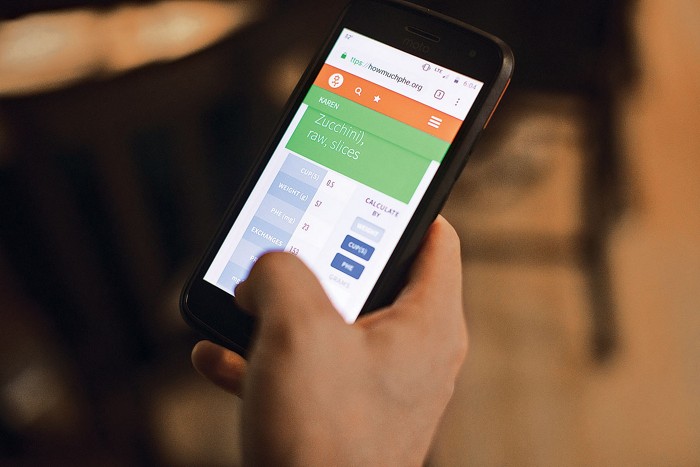 Patrick Ward uses an app to calculate how many milligrams of phenylalanine are in the zucchini to be served with dinner.