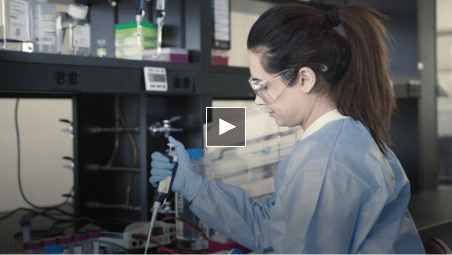 A scientist works with lab equipment